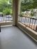 Inviting balcony with iron railings overlooking a peaceful suburban street.
