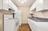 Sleek kitchen with modern white cabinetry, granite countertops, and stainless appliances.