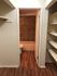 Cozy bathroom entrance with elegant wooden flooring and built-in shelves.