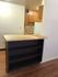 Inviting kitchen space with wooden cabinetry and a versatile countertop shelf unit.