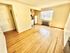 Inviting apartment interior with a bright open kitchen and large window.