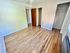 Bright and inviting bedroom with wooden floors and ample closet space.