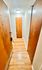 Charming apartment hallway with wooden doors and elegant lighting.
