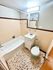 Charming bathroom featuring a classic bathtub, vintage tiles, and a sleek vanity.