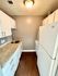 Efficient and stylish kitchen with granite countertops and wooden flooring.