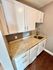 Chic kitchen design with white cabinets, granite countertops, and modern hardware.