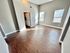 Bright living room with modern hardwood floors and large windows in a contemporary apartment.