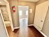 Inviting apartment entrance with stylish hardwood flooring and a view into the well-lit living area.