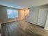 Bright and airy modern living room with sleek hardwood floors and neutral walls.