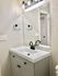 Modern bathroom vanity with sleek black fixtures and mirror.