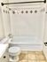 Elegant bathroom with decorative tiled shower and modern fixtures.