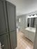 Modern bathroom with elegant cabinetry, sleek vanity, and ambient lighting creating a relaxing atmosphere.