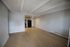 Bright, open-concept living space featuring modern kitchen with sleek appliances and spacious hardwood floors.