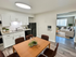 Charming open-concept apartment with a stylish kitchen, inviting dining area, and cozy living room with natural light.