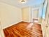 Bright and airy room with elegant wooden flooring and clean, neutral walls, perfect for creative interior designing.