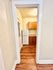 Charming kitchen entryway showcasing warm wood cabinets and sleek appliances, perfect for cozy culinary experiences.