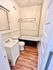 Charming bathroom showcasing a classic clawfoot bathtub, elegant sink, and warm wood flooring.