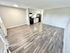 Bright open-concept living area with modern kitchen and sleek flooring, perfect for a contemporary lifestyle.