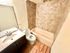 Modern bathroom with elegant tiling, sleek vanity, and luxurious bathtub.