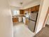 Bright and inviting kitchen with modern appliances, ample cabinetry, and natural lighting.
