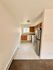 Charming kitchen space featuring modern stainless steel appliances and warm wooden cabinetry, perfect for culinary creativity.