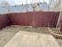 Cozy outdoor space with a rustic wooden fence, perfect for a small garden or private retreat area.