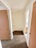 Inviting interior hallway with plush carpet and modern doors leading to bathrooms, enhancing a cozy apartment ambiance.