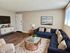 Inviting living room with a chic navy sofa, elegant copper accents, and cozy decor, creating a warm and stylish ambiance.
