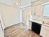 Bright kitchen area with sleek cabinetry, modern appliances, and elegant wood flooring, perfect for culinary enthusiasts.