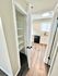 Bright kitchen with elegant cabinetry and open pantry, complemented by sleek wood flooring.