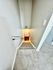 Inviting staircase with soft carpet and sleek gray walls leading to a cozy space.