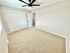 Bright, spacious bedroom with a modern ceiling fan and ample closet space, perfect for a cozy and organized living.