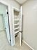 Bright and modern storage closet with built-in shelving, enhancing space efficiency and organization.