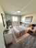 Inviting bedroom with natural light, cozy decor, and a stylish modern design.