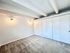 Bright and inviting bedroom with plush carpet, built-in closets, and ambient wall lighting.