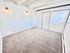 Bright room with plush carpeting featuring modern wall lighting and ample closet space.