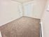 Bright and cozy bedroom with plush carpeting and a spacious closet, ideal for comfort and relaxation.