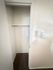 Spacious walk-in closet with plush carpet and ample hanging space.