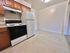 Bright kitchen with modern wooden cabinets and new appliances, perfect for culinary enthusiasts.