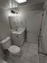 Elegant bathroom with modern vanity, polished marble flooring, and ambient lighting.