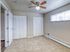 Bright bedroom with plush carpeting, large closet space, and natural light from a wide window, creating a cozy and inviting atmosphere.