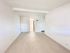 Bright and spacious living area featuring modern flooring and clean white walls, perfect for a contemporary style.