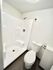 Modern bathroom with sleek shower design and contemporary fixtures, offering a clean and minimalist aesthetic.