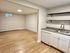 Bright and inviting open-concept space with modern kitchen amenities, sleek hardwood floors, and ample natural light.