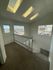 Bright staircase landing with skylights and large windows showcasing picturesque outdoor views, adding a spacious and airy feel.