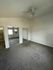 Spacious bedroom featuring plush carpet, mirrored closet doors, and a ceiling fan, offering modern comfort and style.