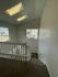 Bright stairwell in a modern apartment with skylights and plush carpeting.
