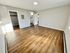 Bright, open bedroom with modern wood flooring, walk-in closet, and sleek en-suite bathroom.