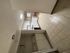 Bright and inviting apartment kitchen with modern appliances, elegant tile flooring, and convenient in-unit laundry for ultimate comfort.