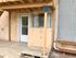 Inviting apartment entrance featuring a white door with glass panels under a covered porch.